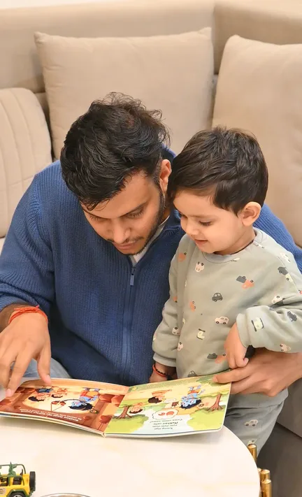 Parent and child reading a NEST storybook together